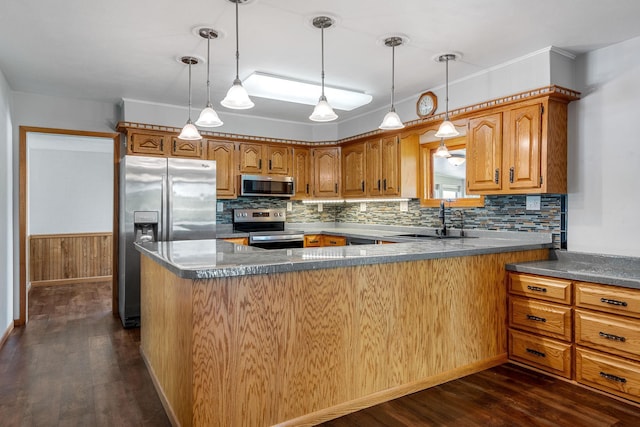 3820 8th St, Owatonna, MN 55060 - kitchen featuring appliances with stainless steel finishes, dark wood finished floors, and backsplash