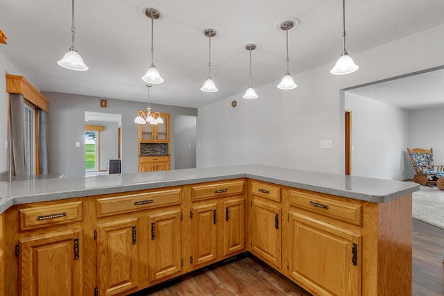 3820 8th St, Owatonna, MN 55060 - kitchen with dark wood-type flooring, pendant lighting, light countertops, and a chandelier