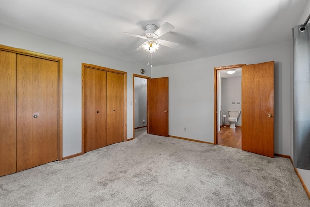 3820 8th St, Owatonna, MN 55060 - unfurnished bedroom featuring two closets, carpet flooring, ensuite bath, and ceiling fan