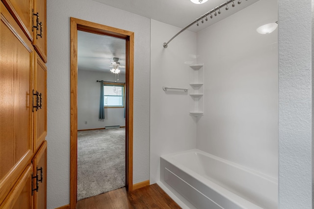 3820 8th St, Owatonna, MN 55060 - bathroom with tub / shower combination, wood finished floors, and a ceiling fan