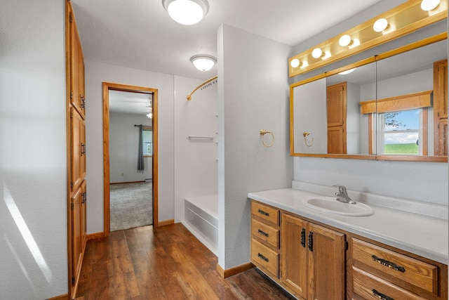 3820 8th St, Owatonna, MN 55060 - full bathroom with vanity, wood finished floors, and  shower combination