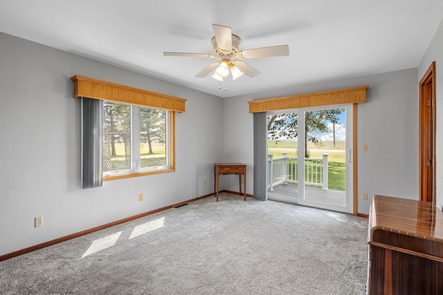 3820 8th St, Owatonna, MN 55060 - carpeted empty room featuring plenty of natural light and ceiling fan