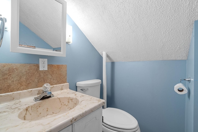 3820 8th St, Owatonna, MN 55060 - half bathroom featuring a textured ceiling, vaulted ceiling, and vanity