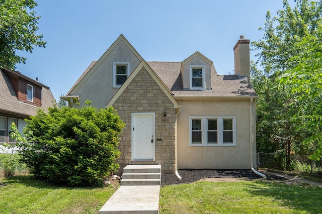 3410 Dupont Ave N, Minneapolis, MN 55412 - view of front facade with stucco siding, a chimney, and stone siding