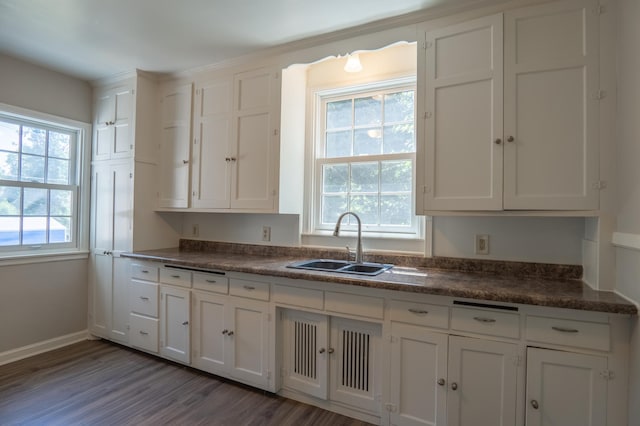 3410 Dupont Ave N, Minneapolis, MN 55412 - kitchen with dark countertops, white cabinetry, and wood finished floors