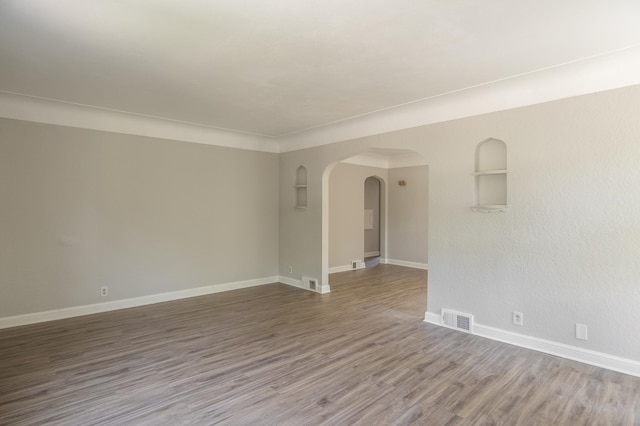 3410 Dupont Ave N, Minneapolis, MN 55412 - spare room with arched walkways and wood finished floors