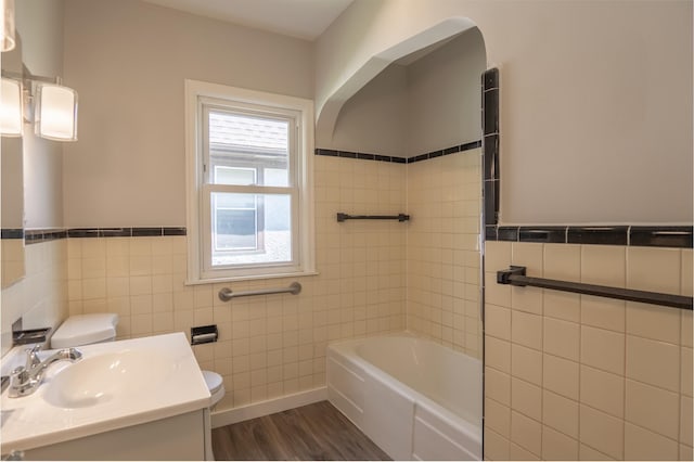 3410 Dupont Ave N, Minneapolis, MN 55412 - full bath featuring tile walls, vanity, wood finished floors, wainscoting, and bathtub / shower combination