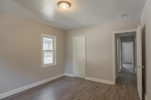 3410 Dupont Ave N, Minneapolis, MN 55412 - unfurnished bedroom featuring dark wood-style floors and a closet