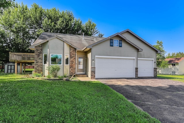 11883 Marigold Way, Lindstrom, MN 55045 - view of front of home with a storage shed, asphalt driveway, a front lawn, brick siding, and a garage