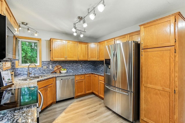 11883 Marigold Way, Lindstrom, MN 55045 - kitchen featuring appliances with stainless steel finishes, light stone countertops, light wood-style flooring, decorative backsplash, and a textured ceiling