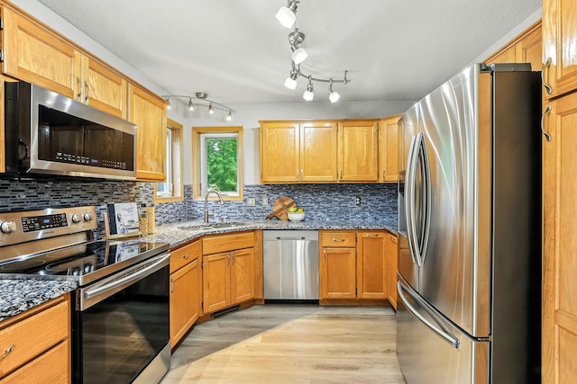 11883 Marigold Way, Lindstrom, MN 55045 - kitchen featuring stainless steel appliances, light wood-style floors, decorative backsplash, and light stone counters