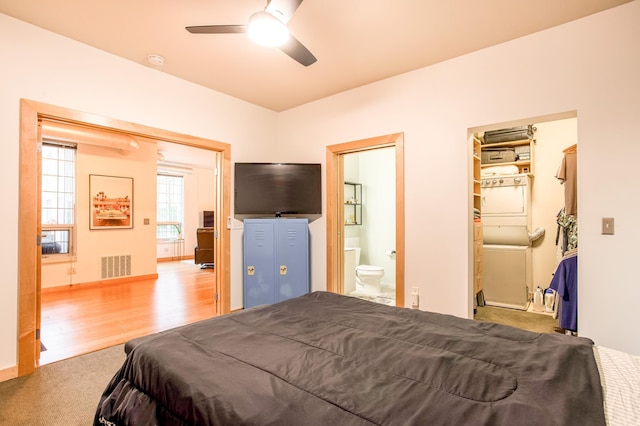 521 2nd St SE Unit 307, Minneapolis, MN 55414 - carpeted bedroom with wood finished floors, ensuite bathroom, and a ceiling fan