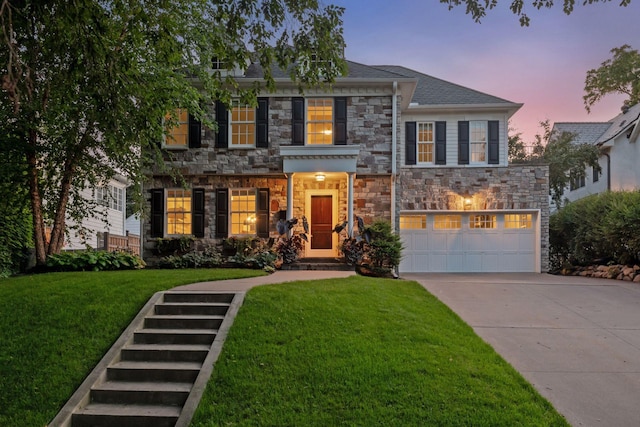 4622 Drexel Ave, Edina, MN 55424 - colonial-style house with stone siding, a garage, concrete driveway, and a front yard