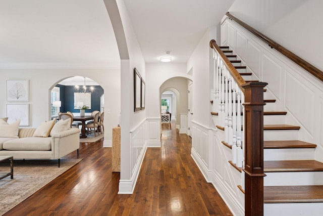 4622 Drexel Ave, Edina, MN 55424 - entrance foyer with arched walkways, a decorative wall, stairway, dark wood finished floors, and wainscoting