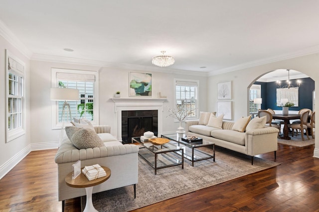 4622 Drexel Ave, Edina, MN 55424 - living area featuring a chandelier, arched walkways, a tiled fireplace, dark wood finished floors, and crown molding