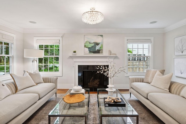 4622 Drexel Ave, Edina, MN 55424 - living room featuring wood finished floors, healthy amount of natural light, a glass covered fireplace, a chandelier, and ornamental molding