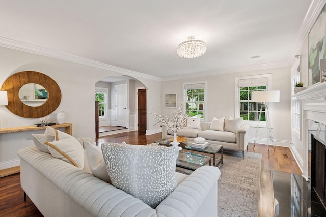 4622 Drexel Ave, Edina, MN 55424 - living area featuring arched walkways, ornamental molding, a chandelier, a fireplace with flush hearth, and wood finished floors