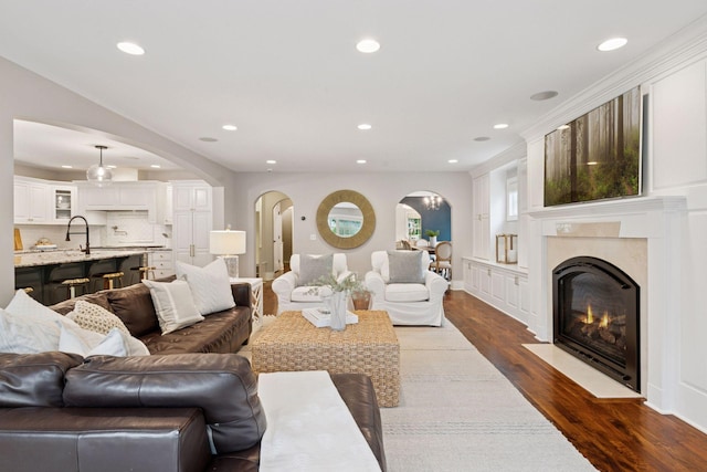 4622 Drexel Ave, Edina, MN 55424 - living room featuring dark wood-style floors, recessed lighting, a premium fireplace, and arched walkways