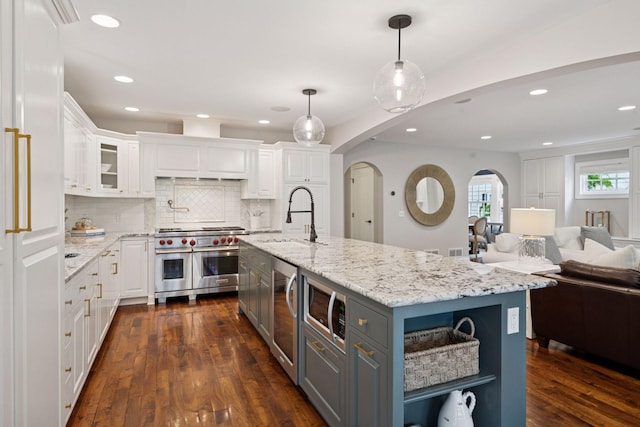 4622 Drexel Ave, Edina, MN 55424 - kitchen with stainless steel appliances, white cabinets, gray cabinetry, backsplash, and recessed lighting