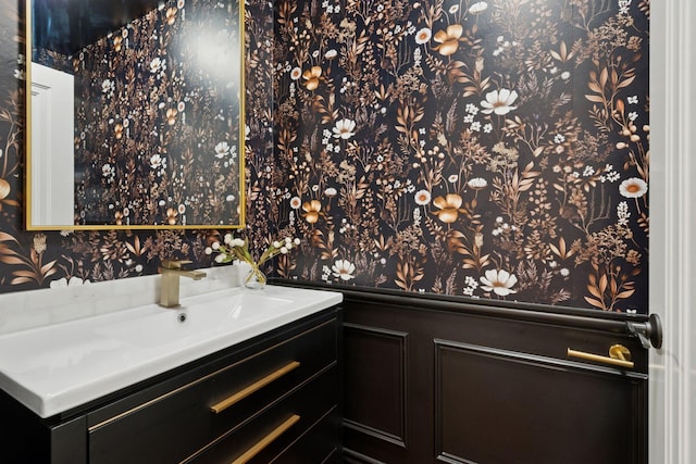 4622 Drexel Ave, Edina, MN 55424 - bathroom with wallpapered walls, vanity, and a wainscoted wall