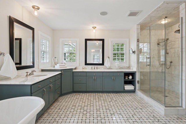 4622 Drexel Ave, Edina, MN 55424 - bathroom featuring a stall shower, two vanities, and plenty of natural light
