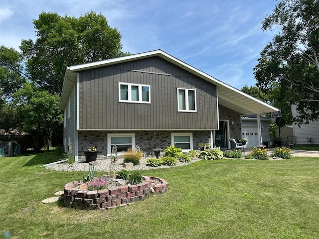 1908 23rd St S, Fargo, ND 58103 - split level home featuring a front yard, a garage, and driveway