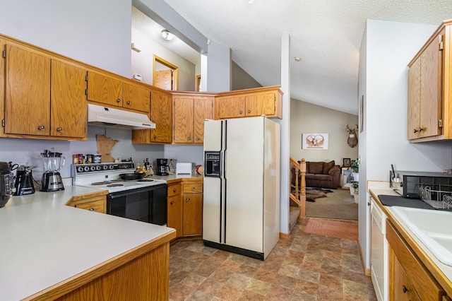 7230 Clear Rdg, Centerville, MN 55038 - kitchen with white appliances, under cabinet range hood, light countertops, stone finish flooring, and high vaulted ceiling
