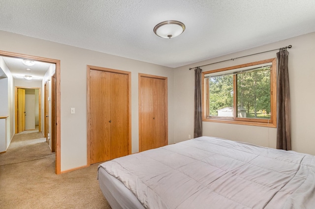 7230 Clear Rdg, Centerville, MN 55038 - bedroom with light carpet, two closets, and a textured ceiling