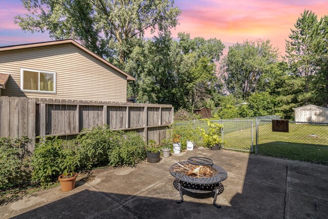 7230 Clear Rdg, Centerville, MN 55038 - fenced backyard with an outdoor fire pit, a patio area, a storage shed, and a gate