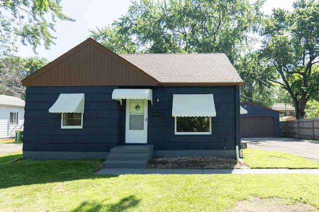 3708 Xenia Ave N, Crystal, MN 55422 - view of front of property featuring roof with shingles, an outdoor structure, and a detached garage