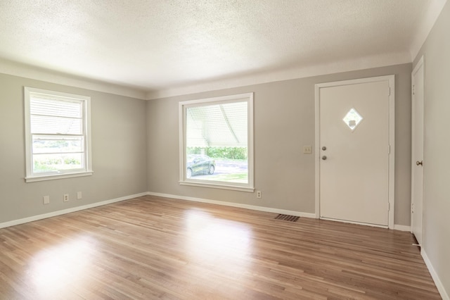 3708 Xenia Ave N, Crystal, MN 55422 - foyer with healthy amount of natural light, light wood finished floors, and a textured ceiling