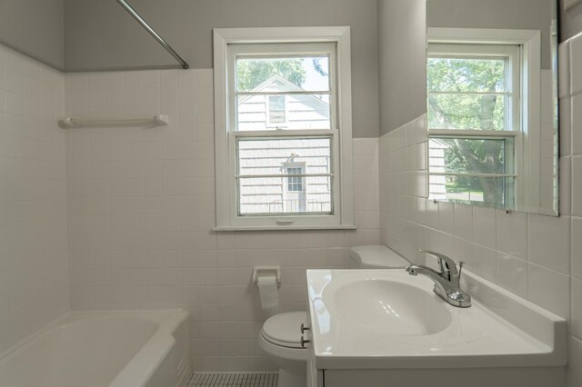 3708 Xenia Ave N, Crystal, MN 55422 - bathroom featuring tile walls, healthy amount of natural light, vanity, and  shower combination