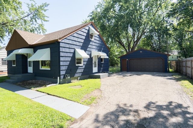 3708 Xenia Ave N, Crystal, MN 55422 - view of front of home with an outdoor structure, a garage, and a shingled roof