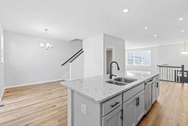 7614 Connie Ln, Inver Grove Heights, MN 55076 - kitchen featuring a chandelier, light wood finished floors, recessed lighting, light stone counters, and a kitchen island with sink
