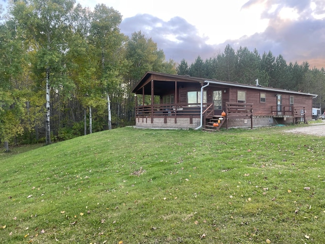 656 22nd Ave NW, Baudette Twp, MN 56623 - rear view of house featuring a yard and a wooden deck