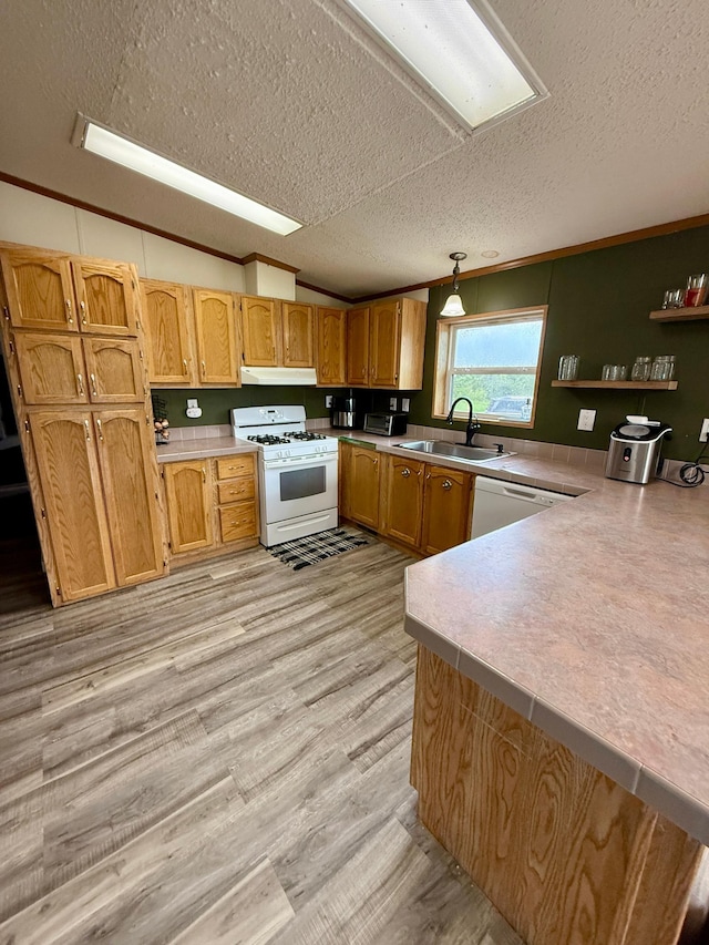 656 22nd Ave NW, Baudette Twp, MN 56623 - kitchen featuring white appliances, a textured ceiling, a peninsula, light countertops, and light wood-style flooring