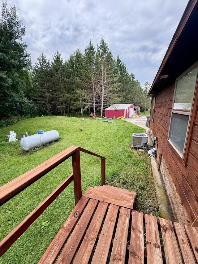 656 22nd Ave NW, Baudette Twp, MN 56623 - wooden terrace featuring a lawn and an outdoor structure