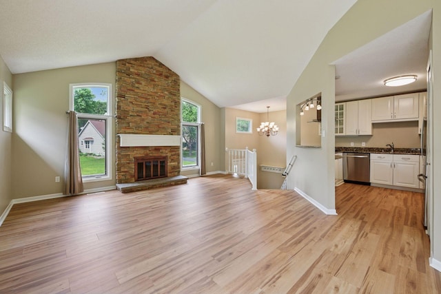 14170 Westridge Dr, Eden Prairie, MN 55347 - unfurnished living room featuring light wood-style flooring, lofted ceiling, healthy amount of natural light, and a chandelier