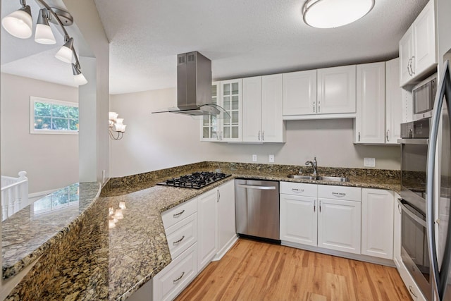 14170 Westridge Dr, Eden Prairie, MN 55347 - kitchen with dishwasher, island exhaust hood, gas cooktop, light wood-style flooring, and white cabinets