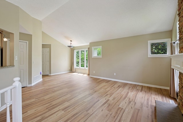 14170 Westridge Dr, Eden Prairie, MN 55347 - unfurnished living room featuring a fireplace, light wood finished floors, and high vaulted ceiling