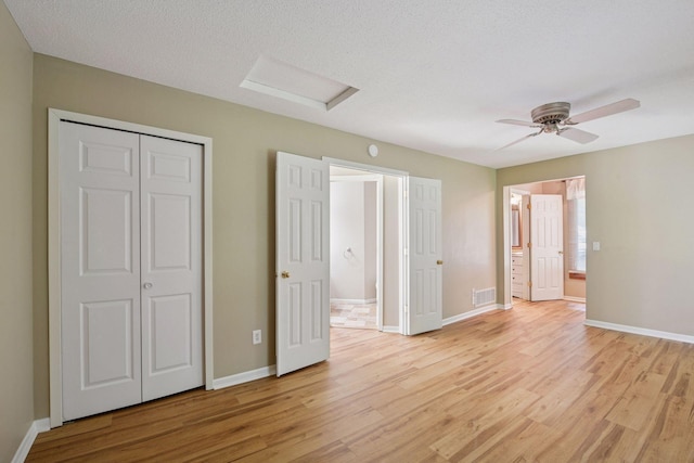 14170 Westridge Dr, Eden Prairie, MN 55347 - unfurnished bedroom with attic access, light wood-style flooring, ensuite bathroom, and a ceiling fan