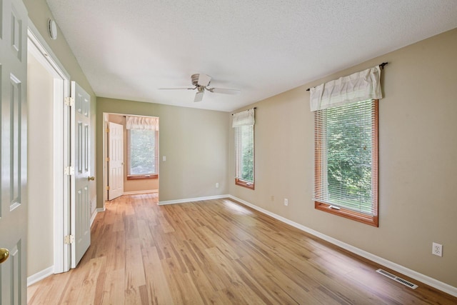 14170 Westridge Dr, Eden Prairie, MN 55347 - spare room with light wood-style flooring, a ceiling fan, and a smoke detector