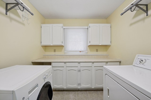 14170 Westridge Dr, Eden Prairie, MN 55347 - laundry room featuring cabinet space, washing machine and clothes dryer, and light tile patterned floors