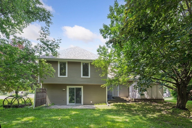 14170 Westridge Dr, Eden Prairie, MN 55347 - rear view of house featuring a yard, a patio, and roof with shingles