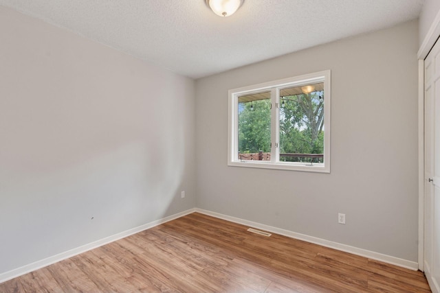 549 Vicki Ln, Shoreview, MN 55126 - unfurnished room featuring light wood finished floors and a textured ceiling