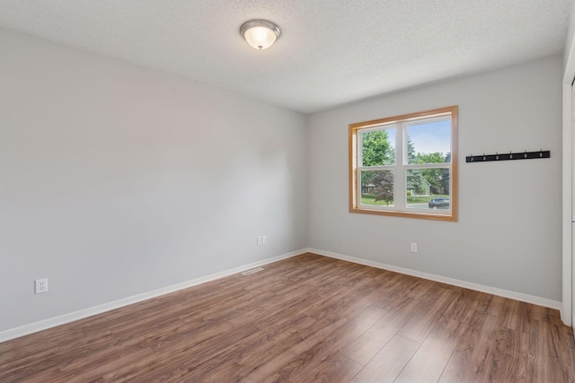 549 Vicki Ln, Shoreview, MN 55126 - unfurnished room with wood finished floors and a textured ceiling
