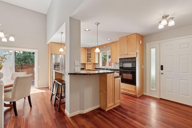 549 Vicki Ln, Shoreview, MN 55126 - kitchen with light brown cabinetry, dark wood-style flooring, a kitchen bar, a kitchen island, and plenty of natural light