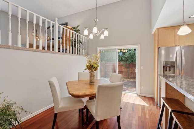 549 Vicki Ln, Shoreview, MN 55126 - dining space featuring light wood finished floors, a chandelier, and a high ceiling