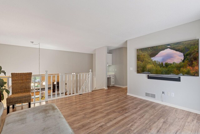 549 Vicki Ln, Shoreview, MN 55126 - unfurnished room with an upstairs landing, light wood-style floors, and a chandelier