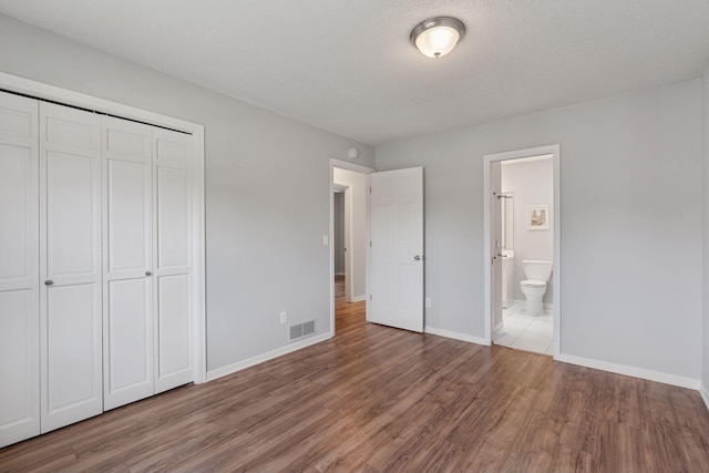 549 Vicki Ln, Shoreview, MN 55126 - unfurnished bedroom with wood finished floors, a closet, and ensuite bath